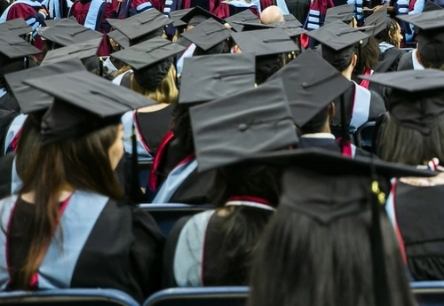 People wearing mortorboards at college commmencement ceremony