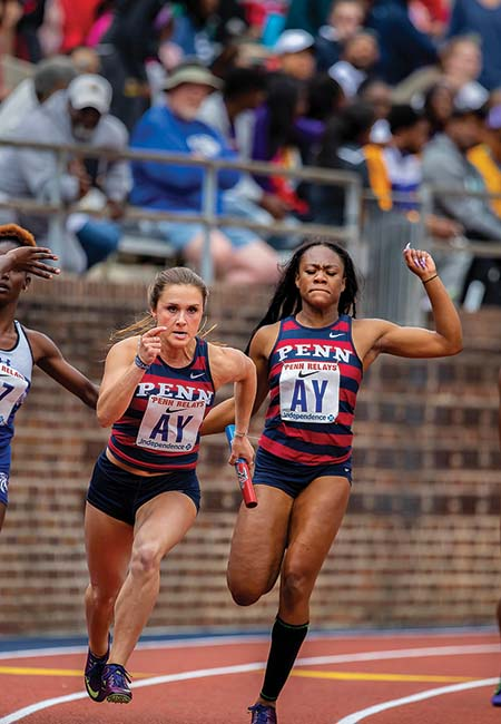 Female athletes race on the tracks in a stadium