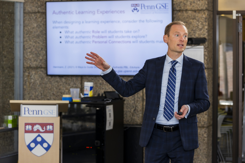 A person presenting next to a podium