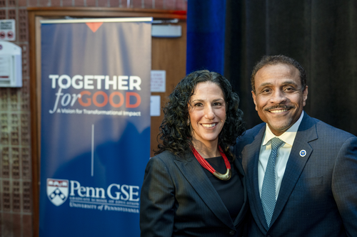 Dean Strunk and Superintendent Watlington smile, wearing dark suits, with a banner reading "Together for Good, Penn GSE" behind them. 