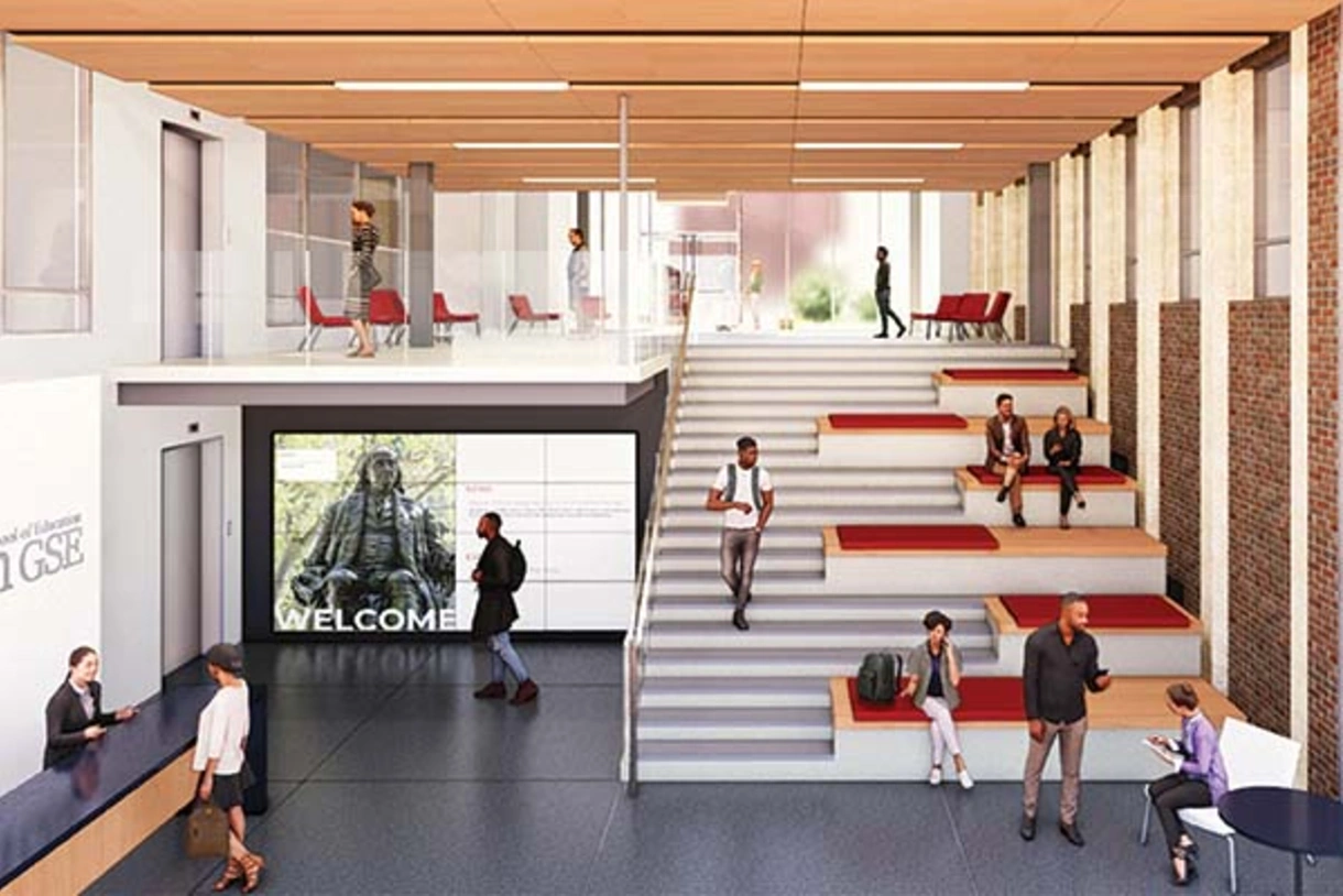 A conceptual design image of Penn GSE’s proposed new lobby. The rendering shows a wide staircase with several lounging spaces and glass windows."