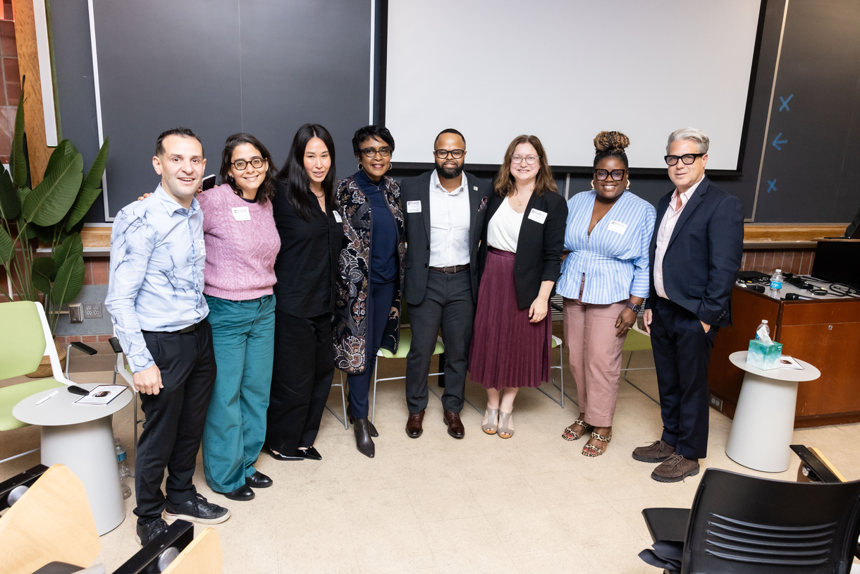 Gadsden surrounded by seven of her former students, now professors, in the room where the symposium was held