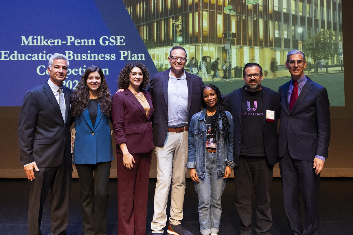 The winners of the 2026 Milken–Penn GSE Education Business Plan Competition (EBPC) stand between Catalyst @ Penn GSE's Entrepreneur-in-Residence John Gamba and Vice Dean of Innovative Programs and Partnerships Michael Golden at the EBPC finals, from left: Juliana Velez of Brikap, Literacy Tree cofounders Stephanie and Adam Newman, Metaschool's Gifty Afful, and Unified Track's Dustin Bainbridge.