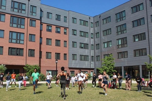students exercising outside on campus