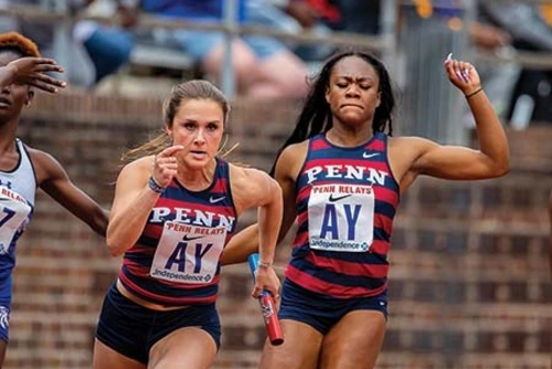 Female athletes race on the tracks in a stadium