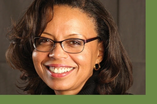 Headshot of Sonia Elliott against a deep brown backdrop
