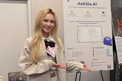 Celine Xu poses with the AskSia table at the Penn Startup Showcase 2025.