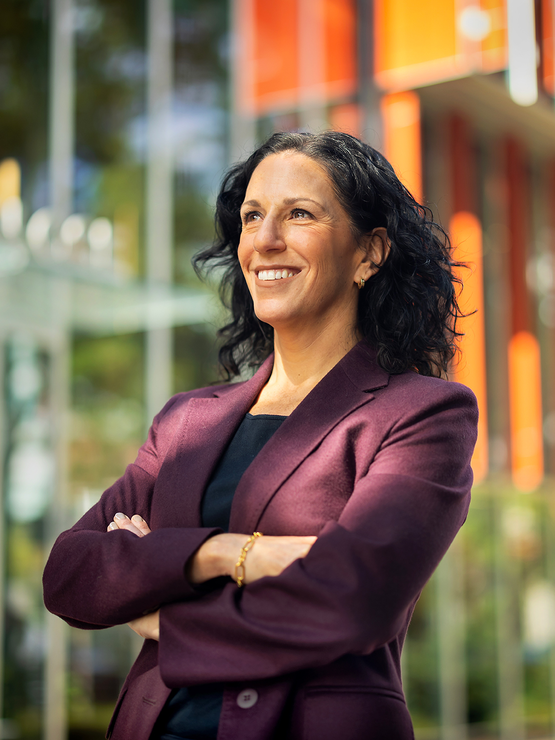Penn GSE Dean Katharine Strunk stands arms folded in front of the entrance to the GSE building