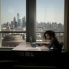 student studying with a laptop from her apartment