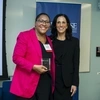 Charlotte Jacobs holds her Alumni Award and poses with the dean at Alumni Weekend. 