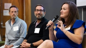 Lara Paparo seated alongside Thinkist executives Jared Wells and Mark Manasse, speaking into a microphone.