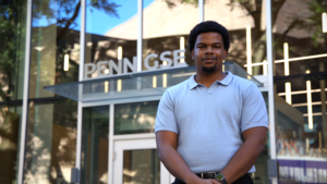Truth Mjumbe poses in front the Penn GSE