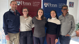From left to right, Zachary Herrmann, Samantha Powers, Gillian Daar, Catherine Zhang, and Rand Quinn pose together in front of Penn Leadership Education Institute banners.