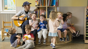 Children enjoy a song with their teacher at the Penn Children's Center
